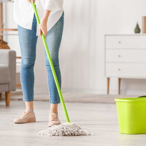 Lady cleaning floor | Rugs Rolls and More